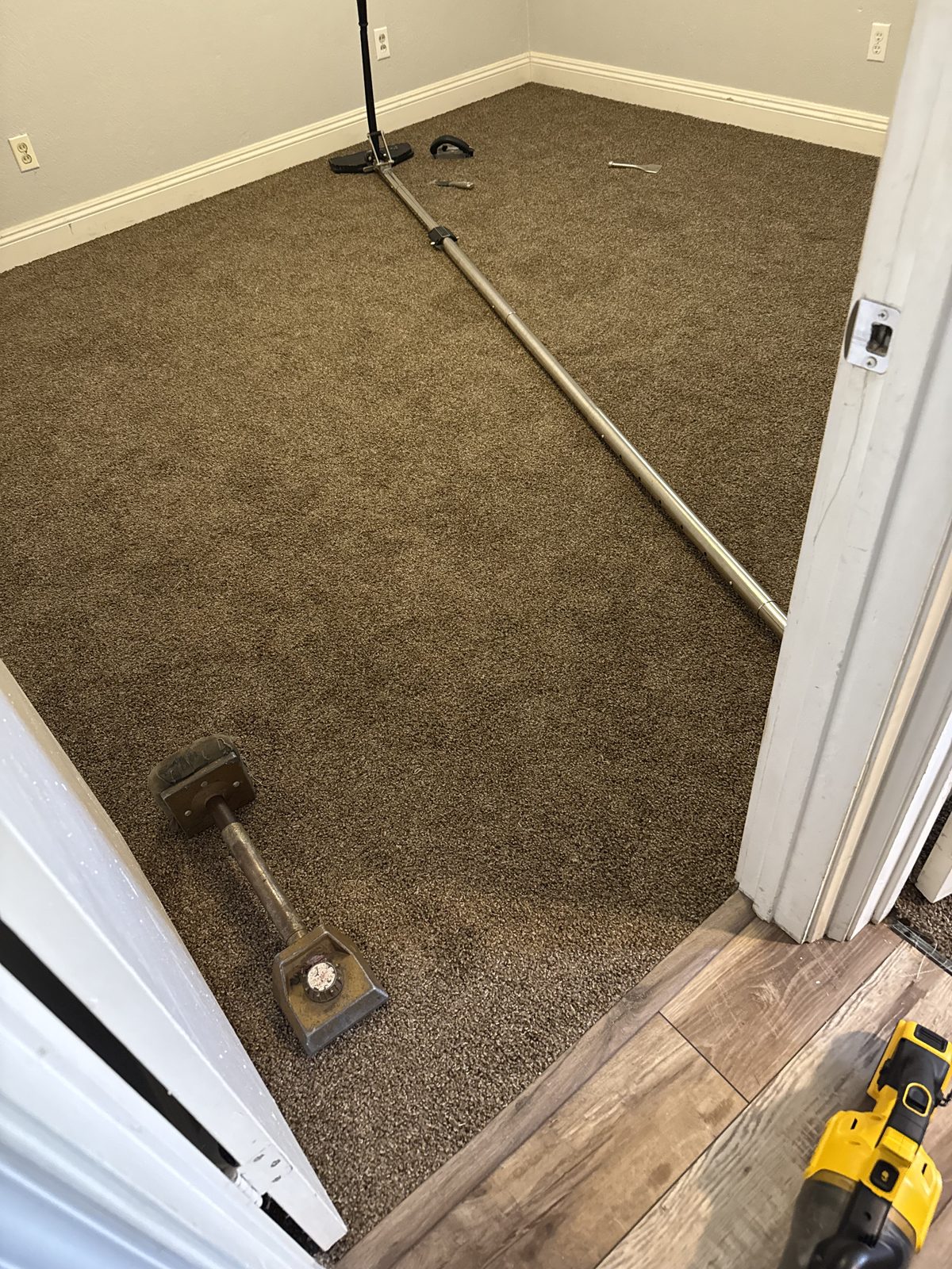Power stretcher and knee kicker set up for a carpet stretching and repair job