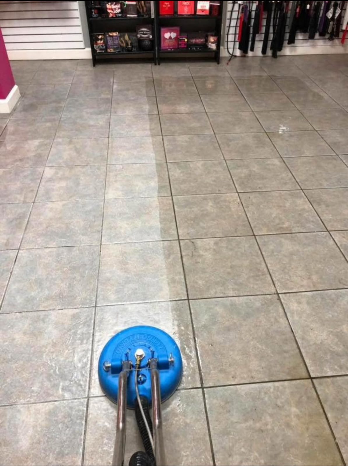 Tile and grout cleaning in progress with rotary tool showing clean vs dirty tile